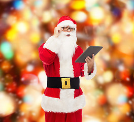 Image showing man in costume of santa claus with tablet pc