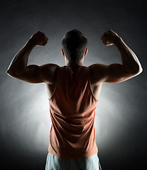 Image showing young man showing biceps