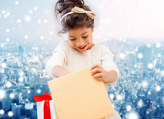 Image showing smiling little girl with gift box