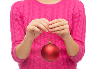 Image showing close up of woman in sweater with christmas ball