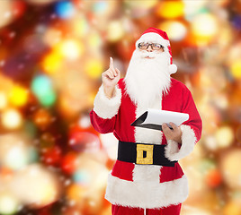 Image showing man in costume of santa claus with notepad