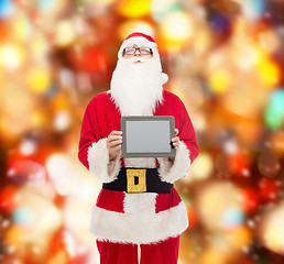 Image showing man in costume of santa claus with tablet pc