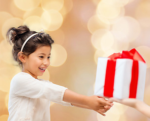 Image showing smiling little girl with gift box