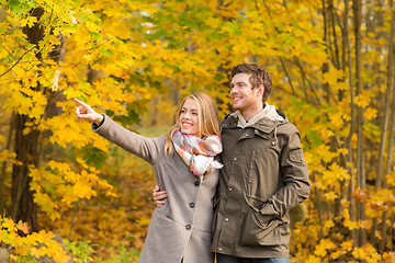 Image showing smiling couple hugging in autumn park