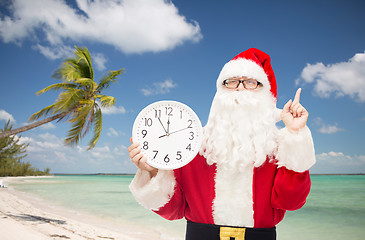 Image showing man in costume of santa claus with clock