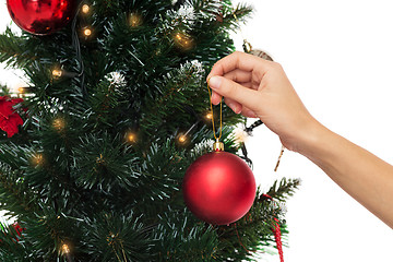 Image showing close up of woman with christmas tree decoration