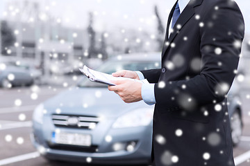 Image showing close up of man with clipboard and car documents