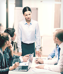 Image showing strict female boss talking to business team