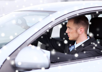 Image showing close up of businessman driving car