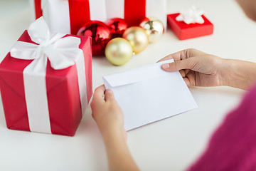 Image showing close up of woman with letter and presents