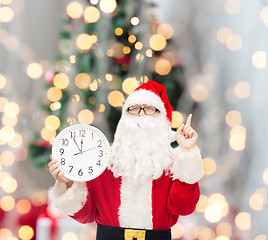 Image showing man in costume of santa claus with clock