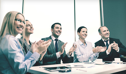 Image showing business team with laptop clapping hands