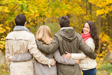 Image showing group of smiling men and women in autumn park