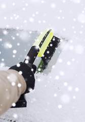 Image showing closeup of man cleaning snow from car