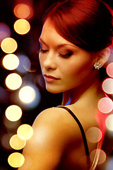 Image showing woman in evening dress wearing diamond earrings