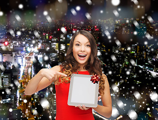 Image showing smiling woman in red dress with tablet pc