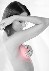 Image showing woman checking breast for signs of cancer