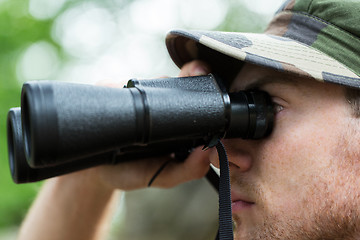 Image showing close up of soldier or hunter with binocular