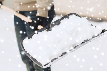 Image showing closeup of man digging snow with shovel