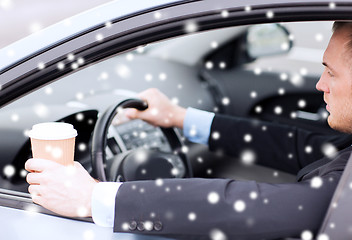 Image showing close up of man drinking coffee while driving car