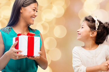 Image showing happy mother and little girl with gift box