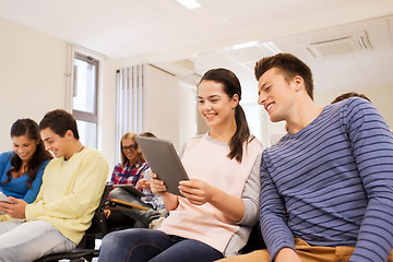 Image showing group of smiling students with tablet pc