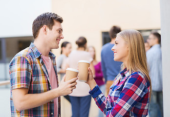 Image showing group of smiling students with paper coffee cups