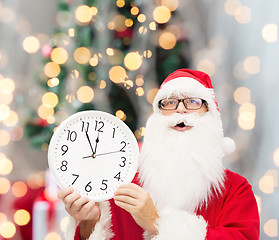 Image showing man in costume of santa claus with clock