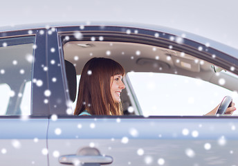 Image showing close up of smiling businesswoman driving car