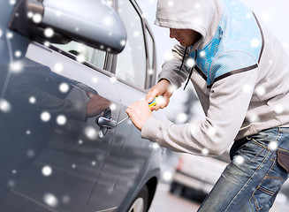 Image showing thief breaking car lock with screwdriver