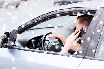 Image showing close up of man using smartphone while driving car