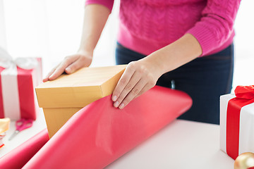 Image showing close up of woman decorating christmas presents