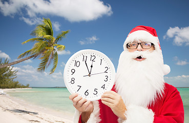 Image showing man in costume of santa claus with clock