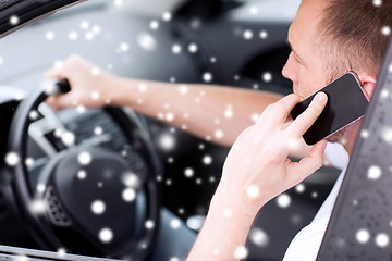 Image showing close up of man using smartphone while driving car