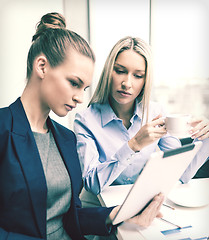 Image showing business team with tablet pc having discussion