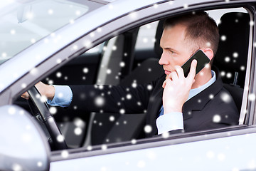 Image showing close up of man using smartphone while driving car