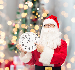 Image showing man in costume of santa claus with clock