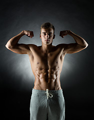 Image showing young man showing biceps