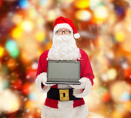 Image showing man in costume of santa claus with laptop