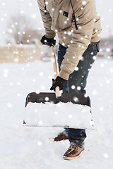 Image showing closeup of man digging snow with shovel