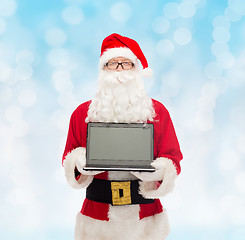 Image showing man in costume of santa claus with laptop