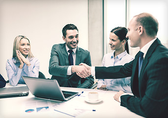 Image showing two businessman shaking hands in office