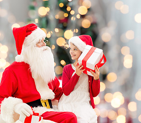 Image showing smiling little girl with santa claus and gifts