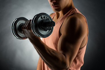 Image showing close up of young man with dumbbell