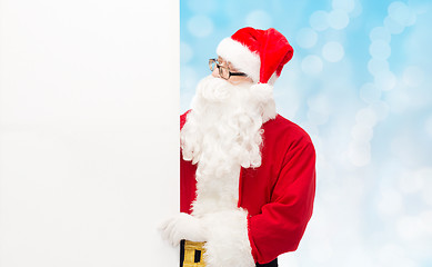 Image showing man in costume of santa claus with billboard