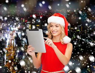 Image showing woman in santa helper hat with tablet pc