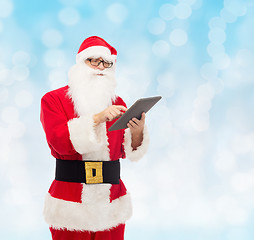 Image showing man in costume of santa claus with tablet pc