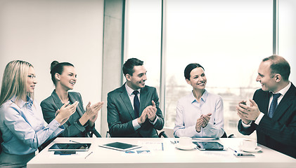 Image showing business team with laptop clapping hands