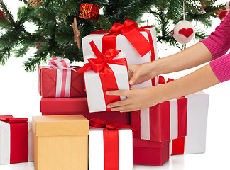 Image showing close up of woman with gifts and christmas tree