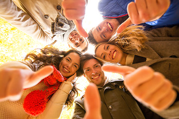 Image showing group of smiling men and women in autumn park